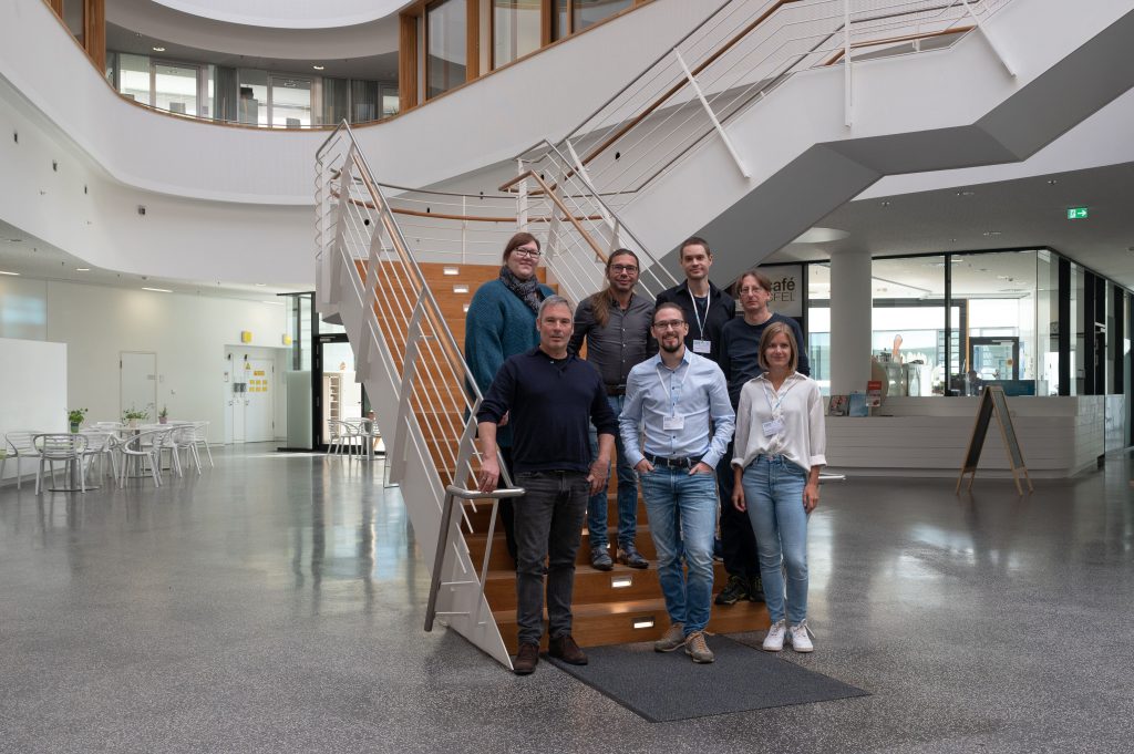 Project partner: Picture of the project team standing on the steps of a staircase